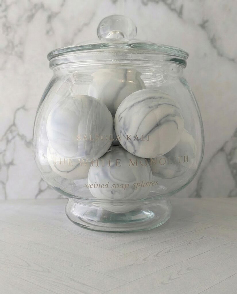 Clean bergamot and mineral air scented White Monolith soap spheres.
