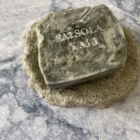 Ash quarried soap bar mimicking the raw texture of natural grey stone.