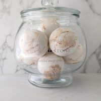 Warm golden mandarin and desert fig scented Sandstone soap spheres.