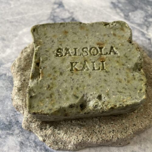 Illite quarried soap showing botanical flecks and hand-fractured stone edges.