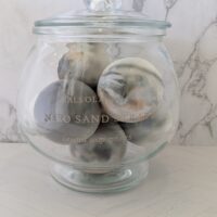 Atmospheric dark woods and mineral warmth scented Nero Sand Strata soap decor.