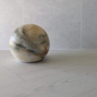 Layered black and grey marble-themed soap spheres by Salsola Kali.