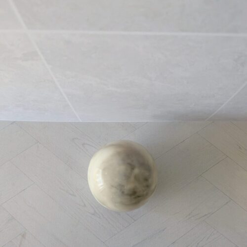 Earth-toned Nero Sand Strata soap spheres for a sophisticated bathroom aesthetic.