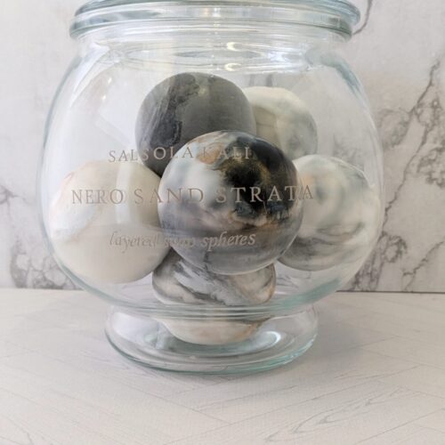 Earth-toned Nero Sand Strata soap spheres for a sophisticated bathroom aesthetic.