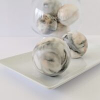 Nero Sand Strata soap spheres with notes of black citrus and smoked tea leaves.
